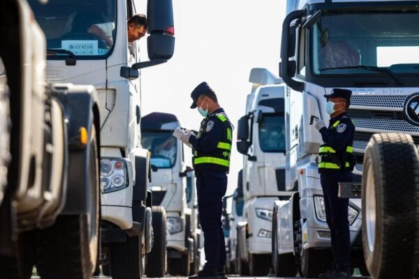 Trucks and freight trains operating at Xinjiang border ports symbolizing China’s westward trade expansion
