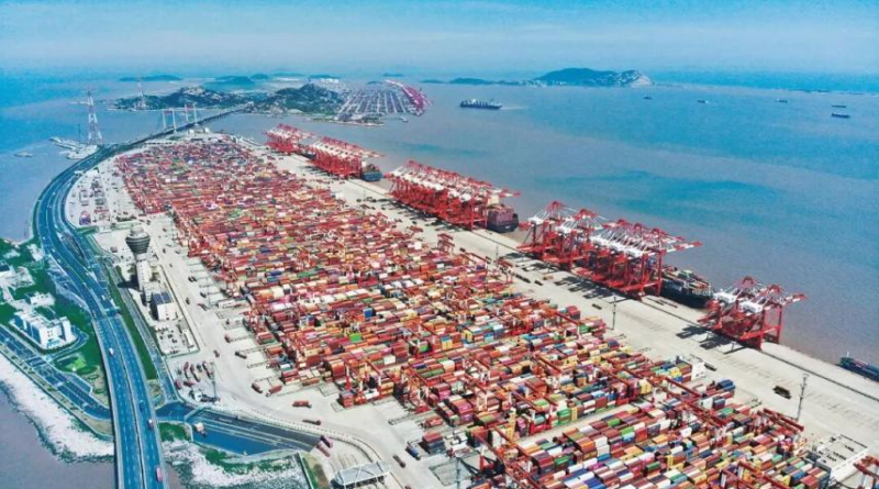 By Han Xin, People's Daily On Xiaoyangshan Island, off Shanghai's southeastern coast, the port hums with nonstop activity. Giant vessels rest alongside the berths. Quay cranes tower overhead. Hundreds of automated guided vehicles (AGVs) move seamlessly between the yard and the shore, sorting and stacking multicolored containers. The entire operation runs with smooth precision -- with barely a human in sight. This is the phase IV automated terminal of Shanghai Yangshan Deep Water Port, the world's largest single-unit automated container terminal. Since it opened in December 2017, the terminal has repeatedly set global records for operational efficiency. At its peak, a single crane has handled over 60 container moves per hour, making it one of the most productive terminals in the world. What gives this port the world's fastest handling speed? The answer lies in its digital brain. In a remote-control operations room, the terminal's digital twin system is on full display. The entire port -- from massive ocean-going vessels down to individual containers -- is mirrored across a wall of digital screens, updated in real time. "Powered by our independently developed intelligent terminal production management and control system, we have achieved unified, end-to-end scheduling of 29 quay cranes, 121 rail-mounted gantry cranes, and 155 AGVs," said Wu Jilin, head of technological innovation at the Shandong Branch of Shanghai International Port Group, which manages and operates the terminal. "This has increased waterfront loading and unloading efficiency and overall yard capacity by about 30 percent compared to traditional operations." The terminal's "mechanical limbs" are equally agile. From the waterfront crew room, twin-lift quay cranes can be seen steadily lifting containers from ships and placing them onto AGVs, which then carry the containers to the yard, where rail-mounted gantry cranes stack them in designated positions. The smoothness of these movements depends on a pair of "nimble hands" located far away. Using the world's first remote-control technology for large-scale cargo-handling equipment based on an F5G all-optical network, crane operators have moved from the driver's cabins at the port to control centers more than 30 kilometers away, and even to remote sites in downtown Shanghai, over 100 kilometers from the terminal. With a simple joystick movement, they maintain precise control. A fully streamlined logistics backbone makes the system even more efficient. Inside a smart heavy-duty truck transport center, a two-level operation space is in view. On the upper level,
